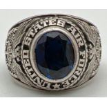 A men's "United States Air Force" dress ring set with an oval cut blue stone. Eagle detail to both