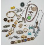 A collection of vintage costume jewellery to include brooches, necklaces and clip on earrings, in