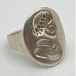 A vintage silver seal ring with classical figure head detail to top. Hallmarks to inside of band.