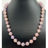 An 18" pink/lilac jade and hematite necklace with decorative leaf shaped S hook clasp. Made from
