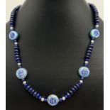 A 17" lapis lazuli and enamelled Chinese beaded necklace with silver tone magnetic barrel clasp.