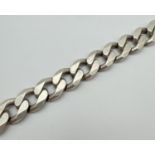 A heavy silver 9 inch large curb link bracelet with lobster clasp. Silver marks to fixings and