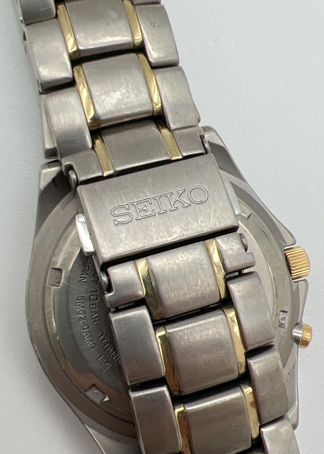 A Seiko 5M62-OAMO kinetic Titanium wristwatch with black face and gold tone hands. Hour markers with - Image 2 of 3