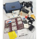 A Minolta 7000 AF 35mm camera with protective case and a collection of lens and accessories. To