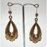 A pair of yellow gold drop style earrings with scroll detail and hooked posts. Approx. 5cm long