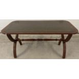 A vintage Bevan Furniture 'Reprodux' X frame coffee table with green leather insert to top.