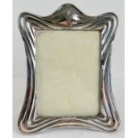 A large Art Nouveau silver fronted picture frame of stylised sinuous design. Hallmarked for