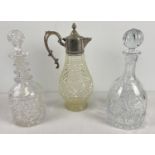 2 heavy cut lead crystal decanters together with a pressed glass claret jug with silver plated