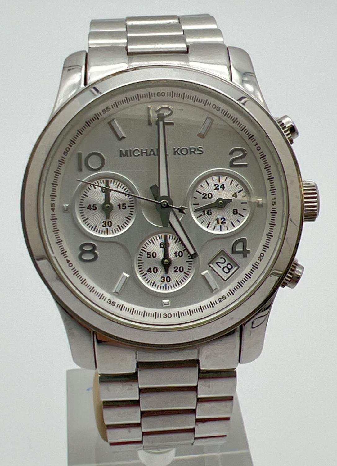 A Michael Kors men's chronograph MK5076 wristwatch. Stainless steel strap and case. White face