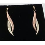 A pair of 9ct gold vintage twist design drop style earrings in duo coloured gold. Complete with