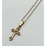 A delicate 9ct gold cross pendant with openwork detail. On a 15 inch fine belcher chain with