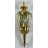 A modern brass replica wall mountable hexagonal coach lantern with clear glass panels. By