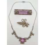 A vintage costume jewellery fixed pendant necklace and matching brooch set with small round cut pink