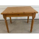 A small sized pine kitchen table with turned legs. Approx. 75 x 92 x 68cm.
