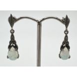 A pair of silver drop style earrings set with teardrop cut opals and marcasite stones. 925 stamped