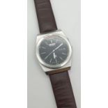 A vintage 072700 Seiko wristwatch with brown leather strap. Black face with luminous hour markers