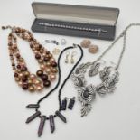 A collection of vintage and modern costume jewellery to include matching necklaces and earrings.