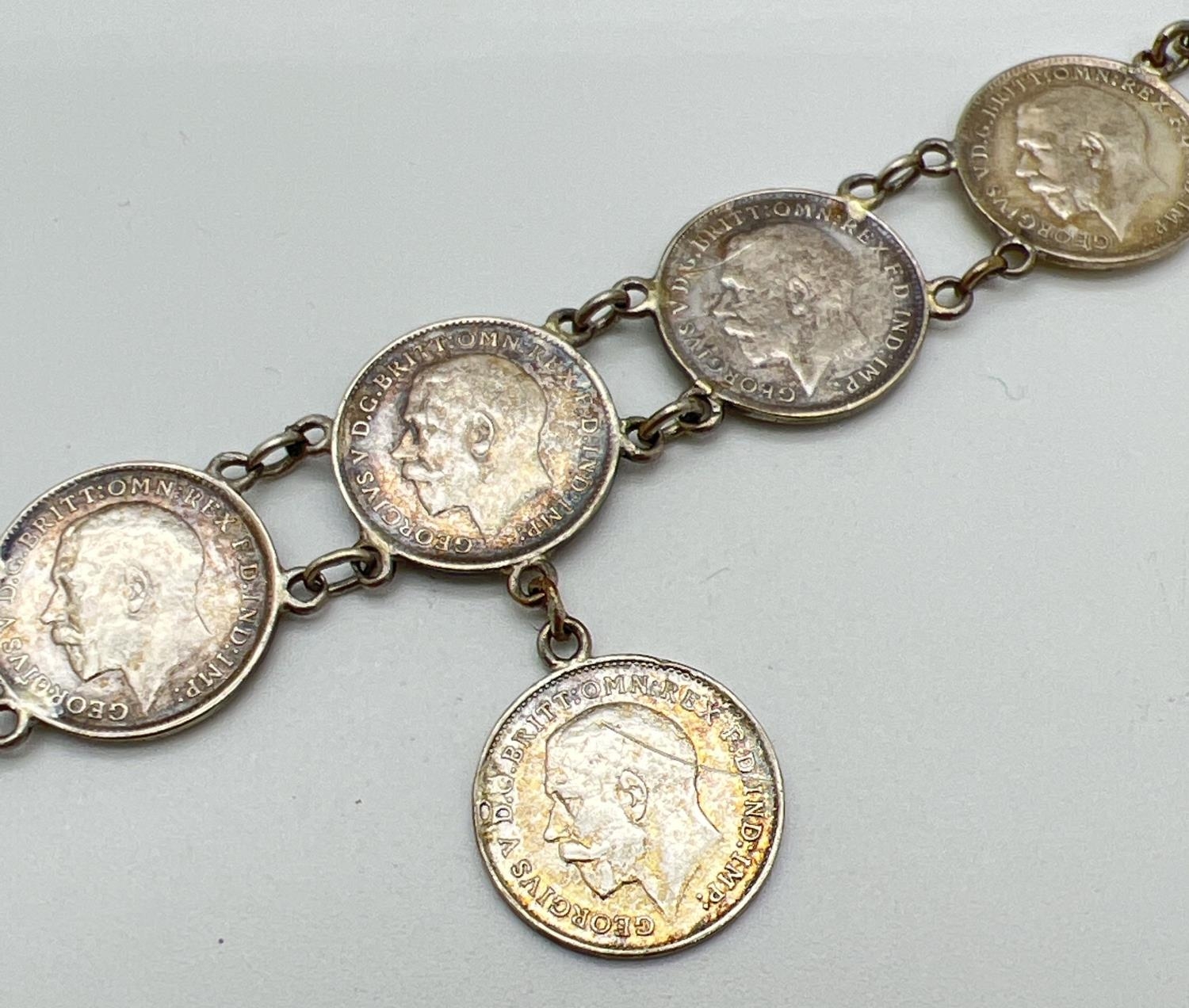 A vintage silver bracelet made from George V silver three pence coins, all dated 1911, 1915 and - Image 2 of 3