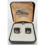 A pair of Siam silver cufflinks with Thai temple decoration in a Shields, Fifth Avenue box. Marked