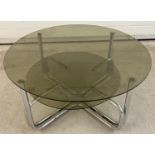 A retro style glass and chrome circular coffee table with undershelf. Approx. 24 tall x 71.5cm