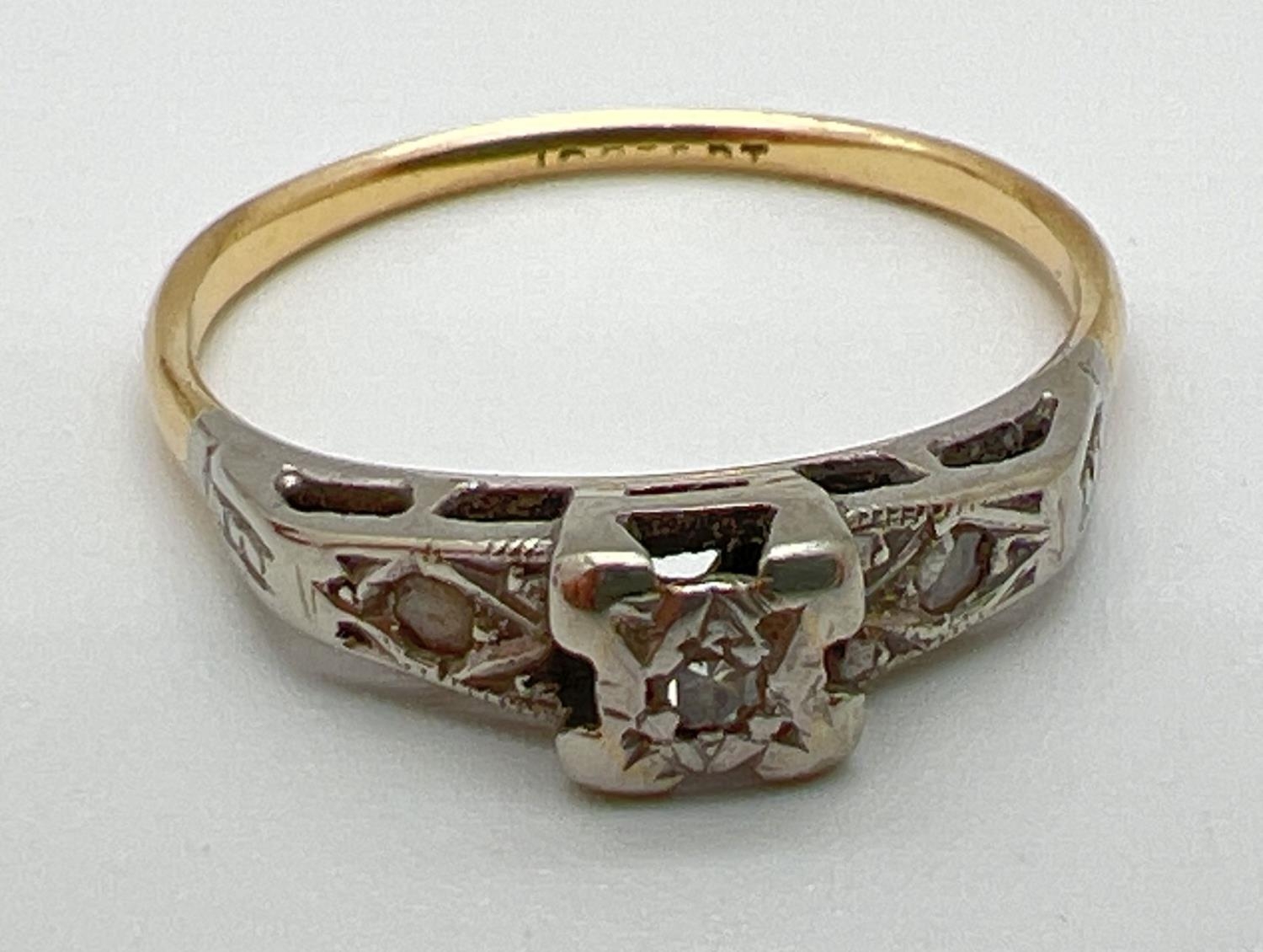 An 18ct gold Art Deco illusion set diamond dress ring. Central square mount set with a single