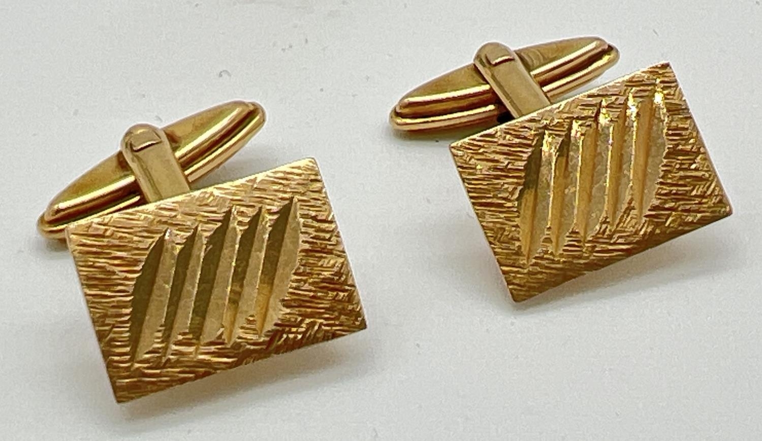 A pair of vintage 9ct gold square shaped cuff links with brushed detail & etched line decoration.