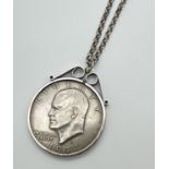 A 1974 American dollar in a silver mount. On a 22 inch silver belcher chain with spring clasp.
