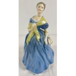 A ceramic figurine of "Adrienne", HN2304 by Royal Doulton. Blue dress and bow to hair with pale