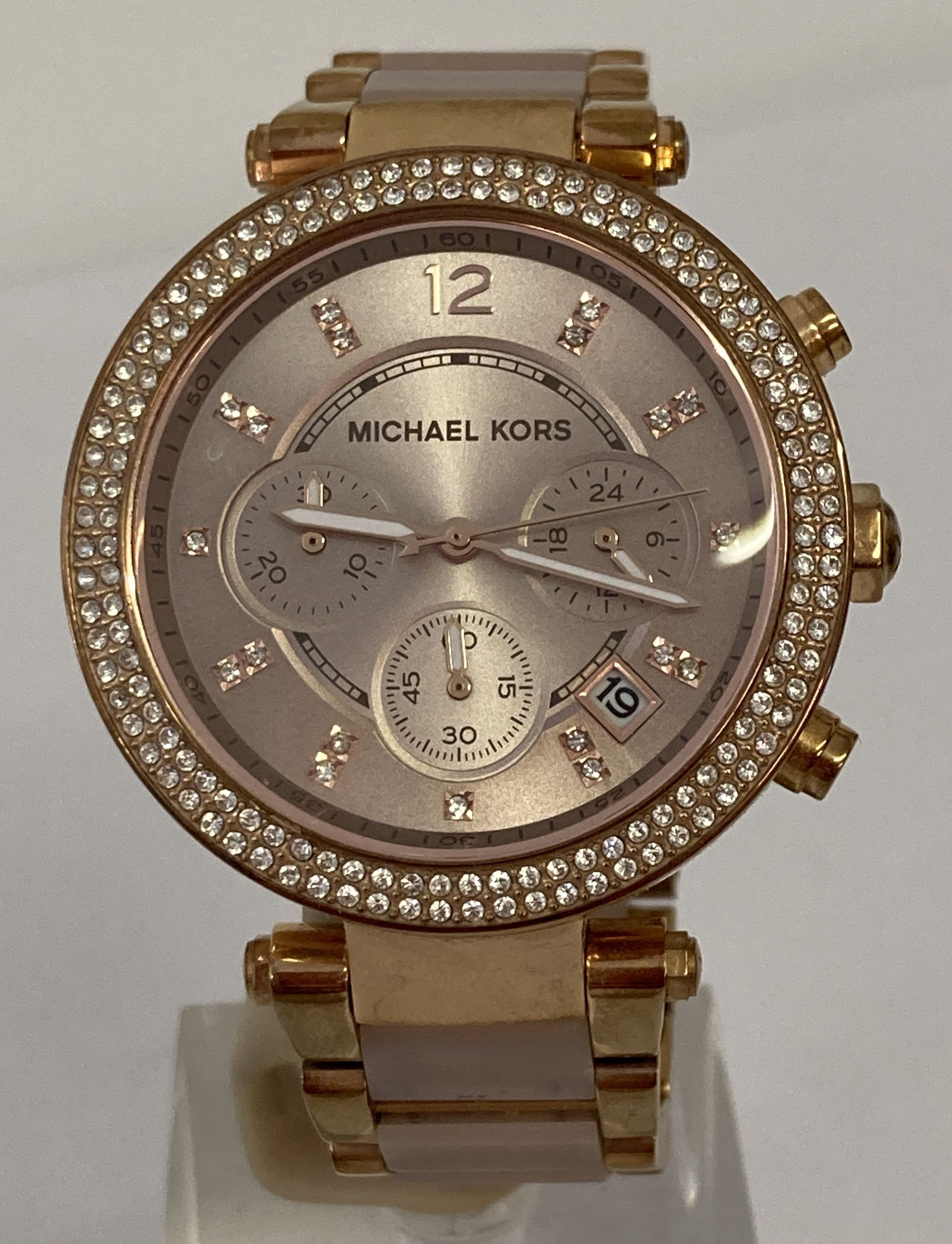 A Michael Kors "Parker" ladies chronograph wrist watch in rose gold finish with blush pink links.