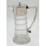 An Edwardian silver and cut glass claret jug with faceted body and channelled detail. Angular shaped