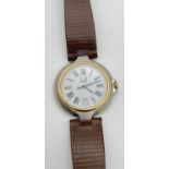 A men's vintage Dunhill wristwatch with stainless steel case and brown leather strap. White face