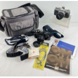 An Olympus OM-1 camera with a Hoya 49mm UV(O) lens, complete with instruction booklets and neck