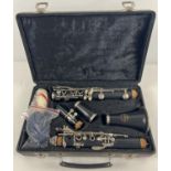 An Earlham clarinet in hard carry case, complete and with cork grease pot, cleaning rods & cloths.