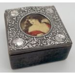 A small Edwardian wooden trinket box with decorative silver lid. Round panel to lid depicting the