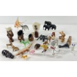 A collection of assorted vintage miniature animal figures to include glass, wood, ceramic, felt