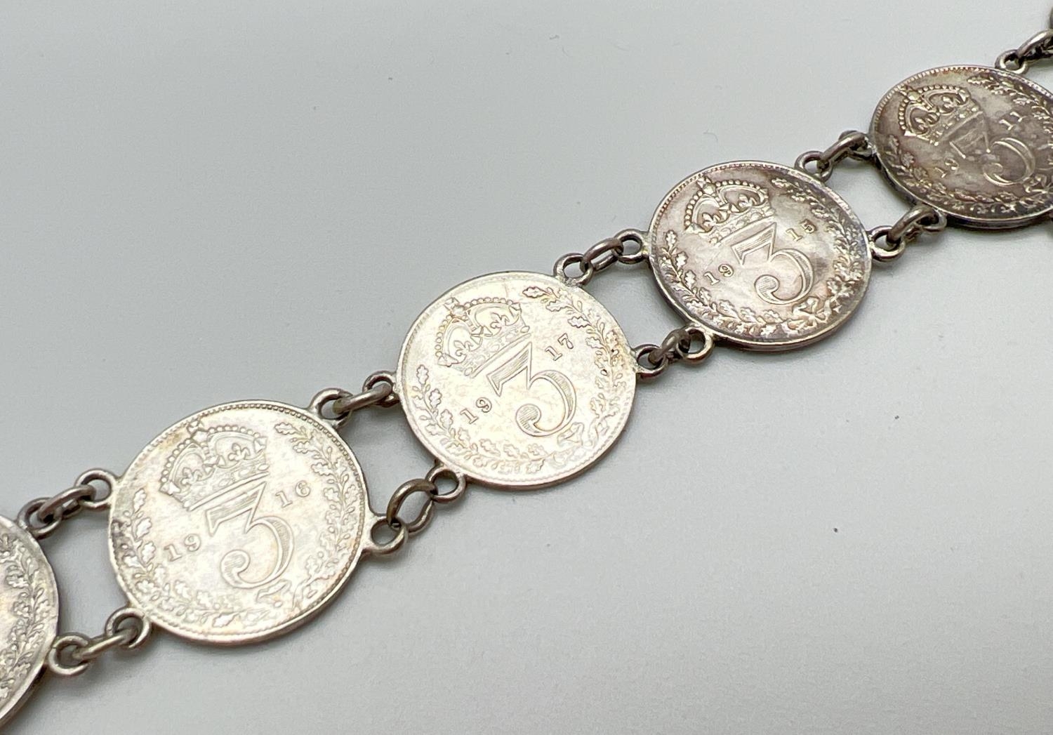A vintage silver bracelet made from George V silver three pence coins, all dated 1911, 1915 and - Image 3 of 3