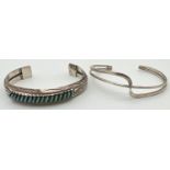 2 silver modern design cuff style bangles. A interlocking bangle with engraved decoration and set