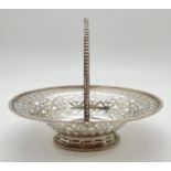 An antique George III silver sweetmeat basket with decorative pierced and engraved body. Hinged