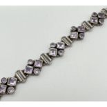 A modern design silver and amethyst bracelet with lobster clasp. 8 links all set with 2 square cut