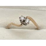 A vintage 9ct gold double diamond twist design dress ring. Two single 0.07 carat diamonds in a