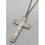 An Edwardian silver cross pendant with floral engraving to front. On a 22 inch chain (not silver).