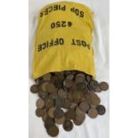 A large collection of antique and vintage one penny coins in a yellow cloth money bag. Sovereign