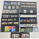 A collection of 13 Royal Mail mint collector stamp sets. To include: Brunel, James Bond, RSA,