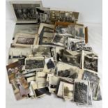 A box of assorted Edwardian & vintage black & white photographs and postcards.