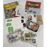 A vintage "Gay Venture" stamp album containing a collection of British and world stamps. Together