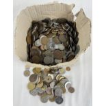 A box of mixed vintage British and foreign coins. British coins include sovereign heads of Victoria,