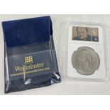 A cased collectors 1965 Churchill crown with 1946 George VI 4d stamp depicting Sir Winston