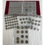 A red collectors album of vintage British coins - sovereign heads of George VI and Elizabeth II.