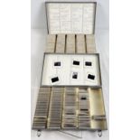 2 metal carry cases containing approx. 330 assorted vintage photographic slides. Each hand written