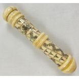 A carved bone Scrimshaw style screw top needle case with carved Royal Crest. Approx. 16.5cm long.